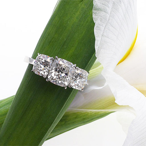 14K diamond engagement ring featuring 3 cushion-cut diamonds in a 4-prong claw setting. Judith Arnell Jewelers