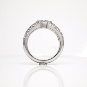 Platinum diamond engagement ring featuring one 0.70 carat oval diamond (SI1, E color), and pave set diamonds weighing a total of 0.75 carats.