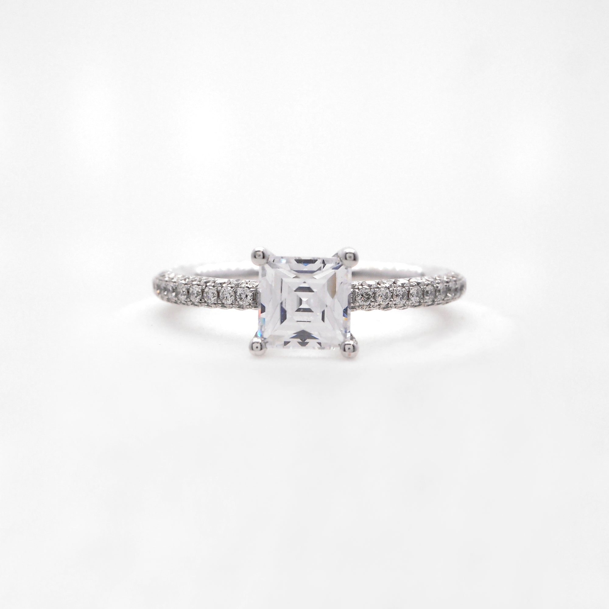 18K white gold diamond engagement ring with pave-set round brilliant diamonds weighing a total of 0.85 carats. 