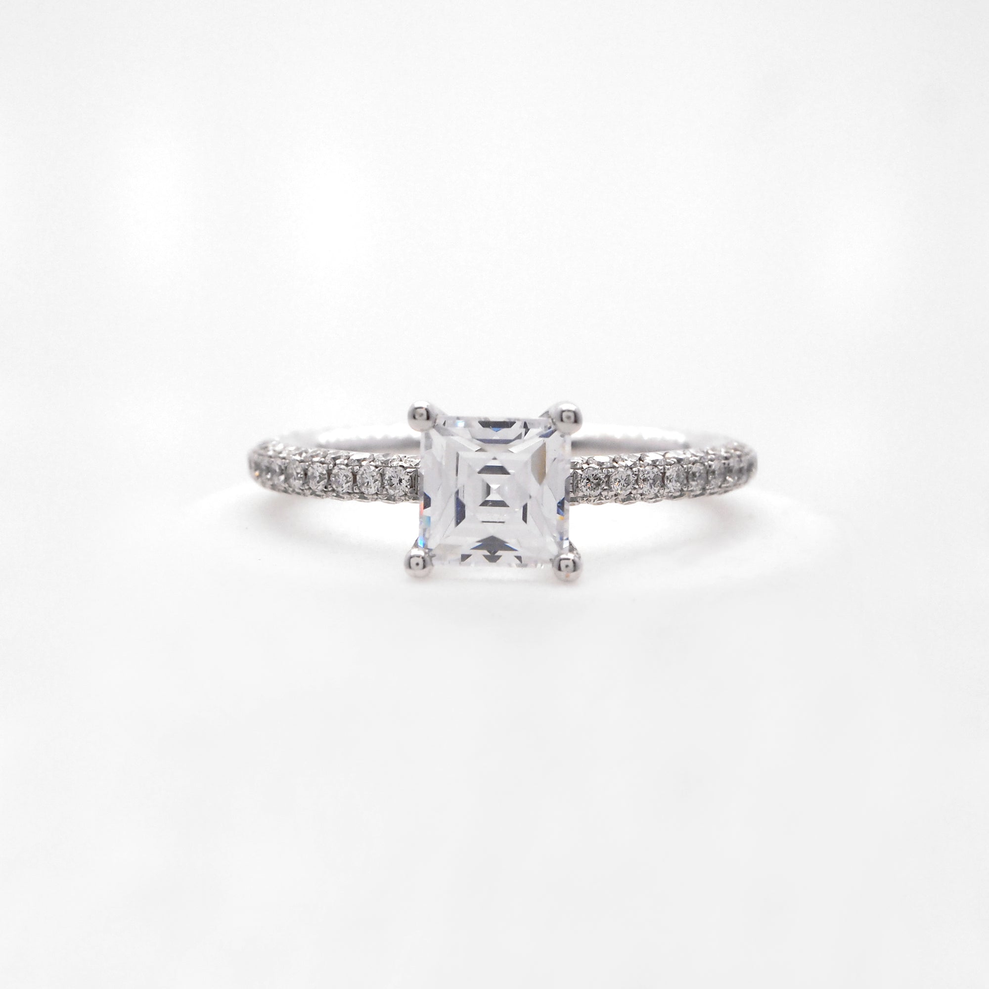 18K white gold diamond engagement ring with pave-set round brilliant diamonds weighing a total of 0.85 carats. 