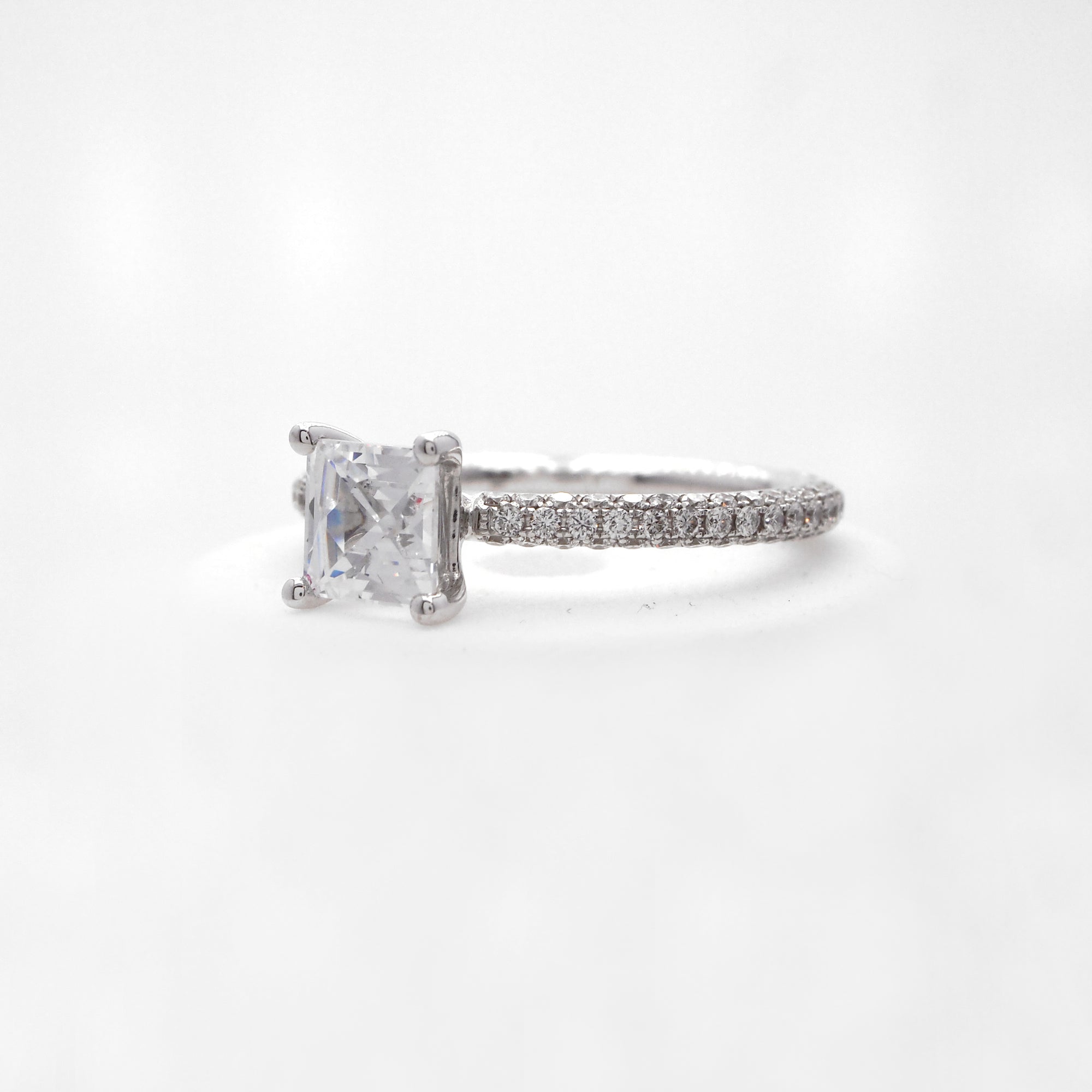 18K white gold diamond engagement ring with pave-set round brilliant diamonds weighing a total of 0.85 carats. 