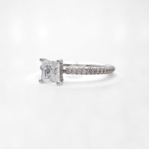 18K white gold diamond engagement ring with pave-set round brilliant diamonds weighing a total of 0.85 carats. 