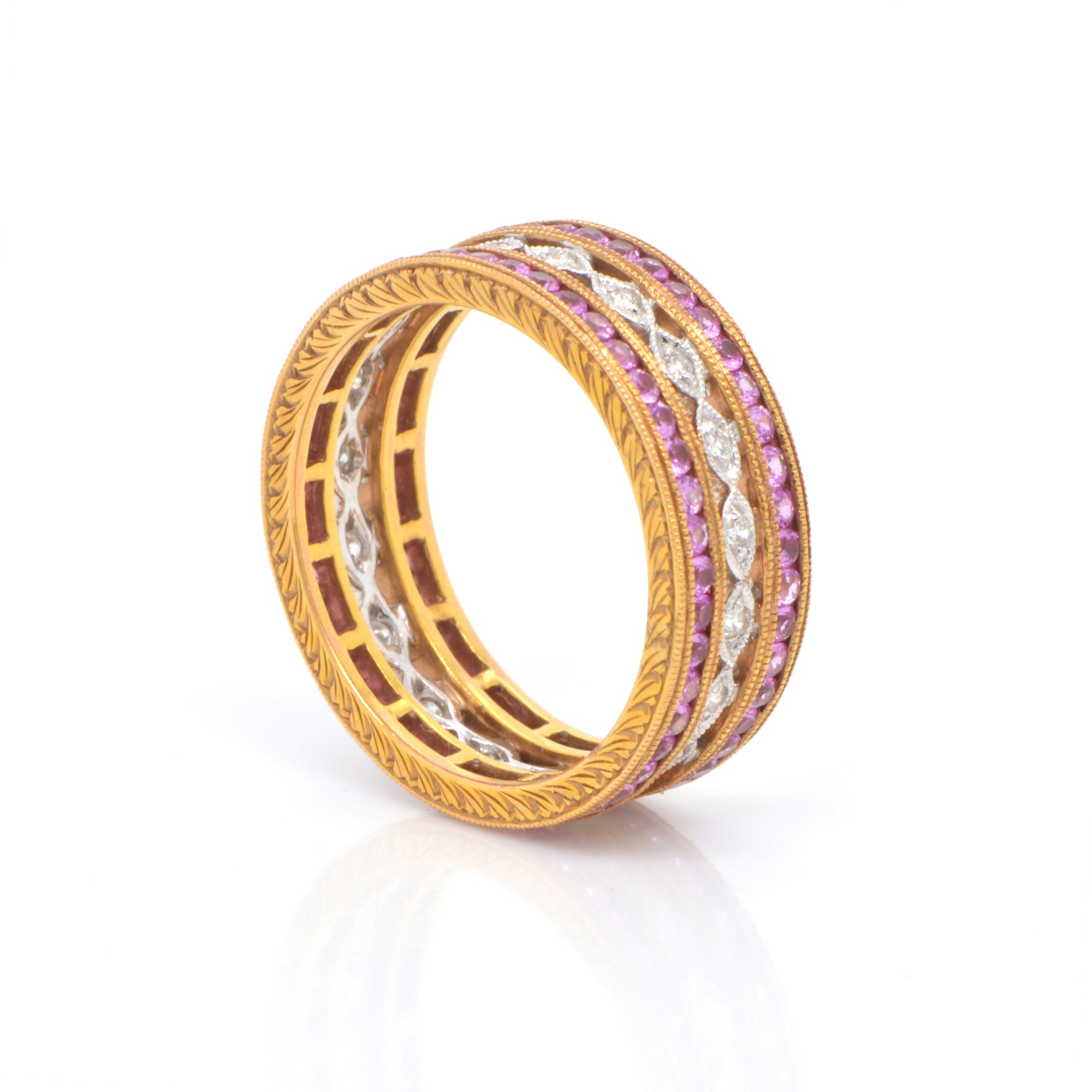 18K rose and white gold eternity band featuring rows of pink sapphires (1.35ctw) in rose gold, and round brilliant diamonds (0.14ctw) on a white gold band in a full eternity design. 