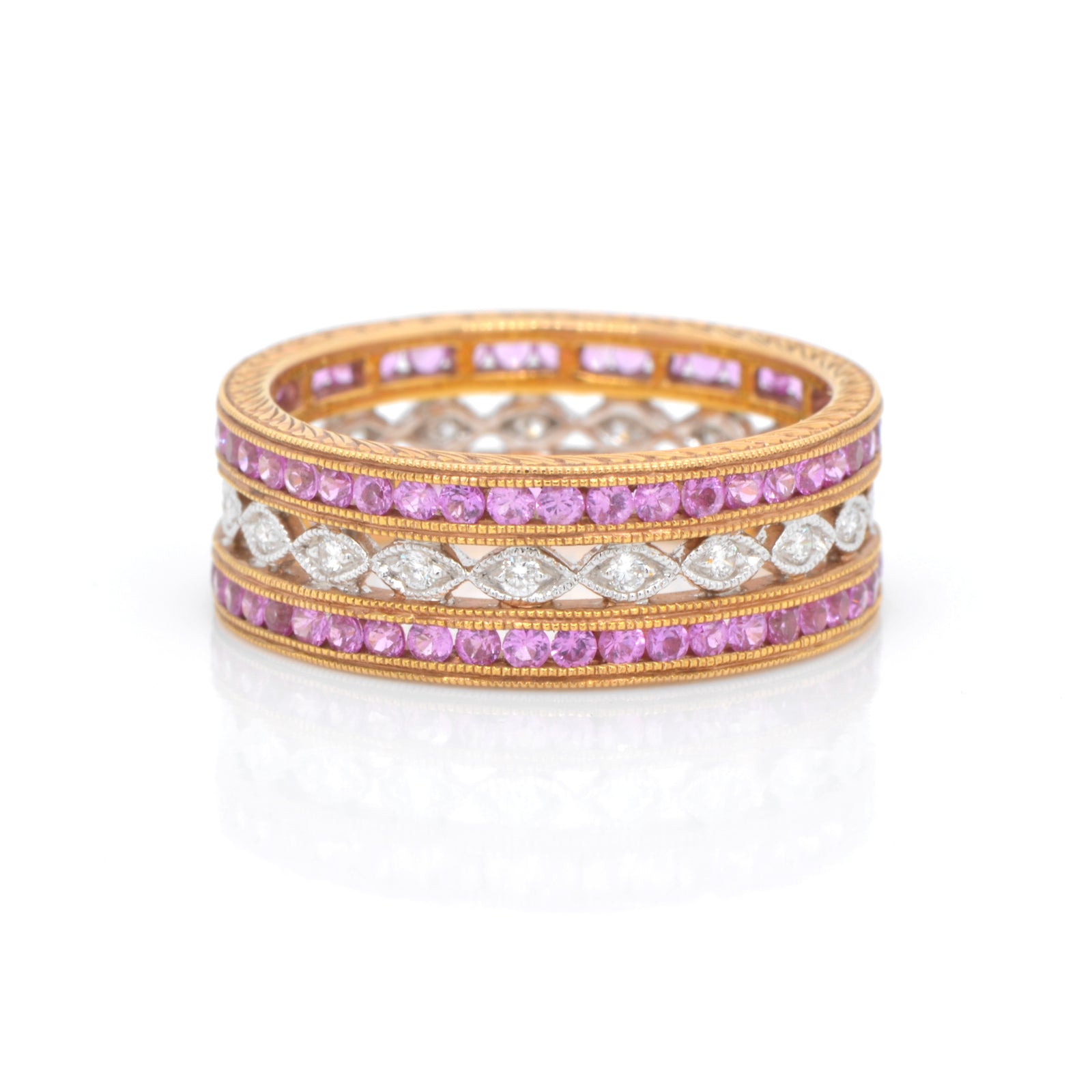 18K rose and white gold eternity band featuring rows of pink sapphires (1.35ctw) in rose gold, and round brilliant diamonds (0.14ctw) on a white gold band in a full eternity design. 