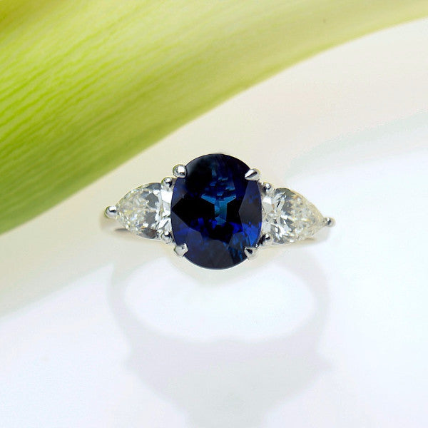 White Gold Three-Stone Ring with One Certified Natural Blue Sapphire and Two Pear Shaped Diamonds