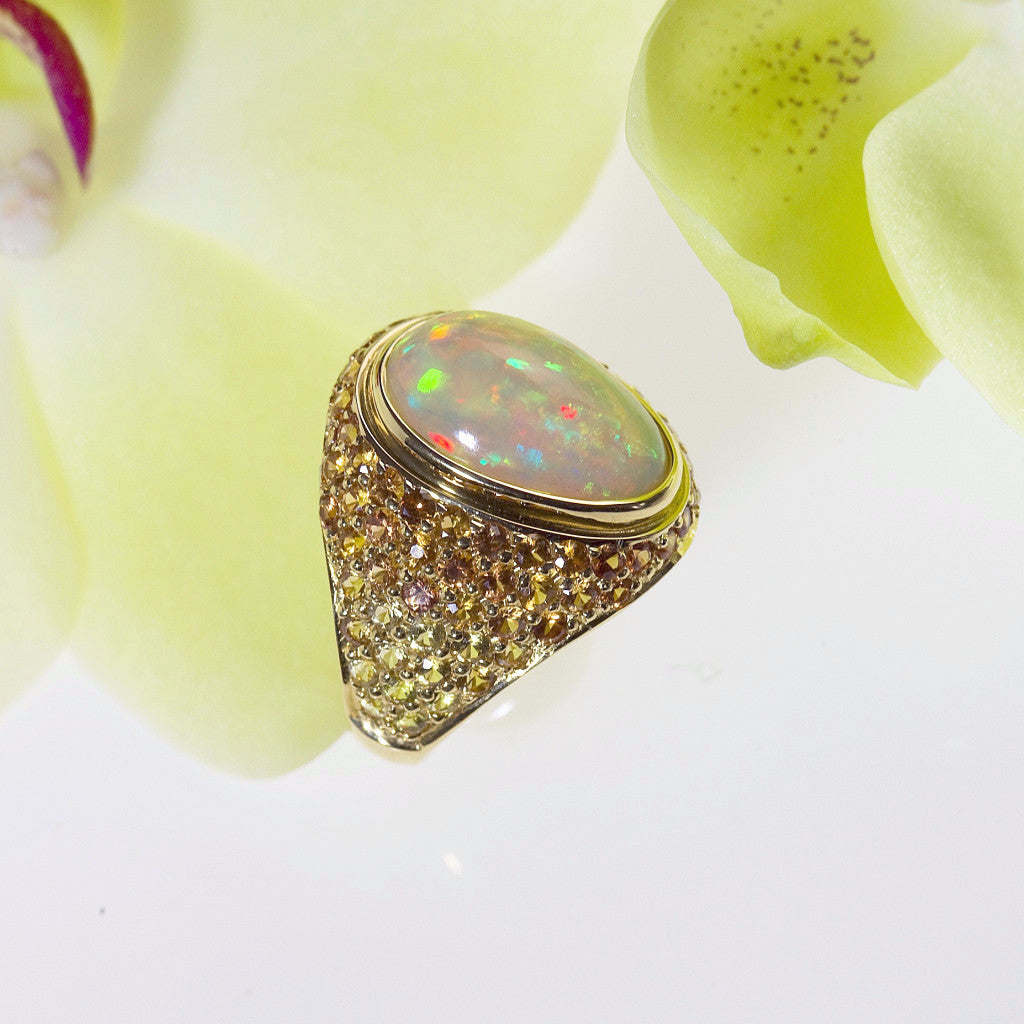custom design handmade yellow gold opal ring with yellow, gold, and orange sapphires