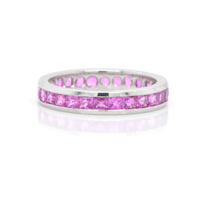 Platinum sapphire eternity band featuring princess-cut pink sapphires (2.43ctw) channel set in bright, white platinum in a full eternity design. 