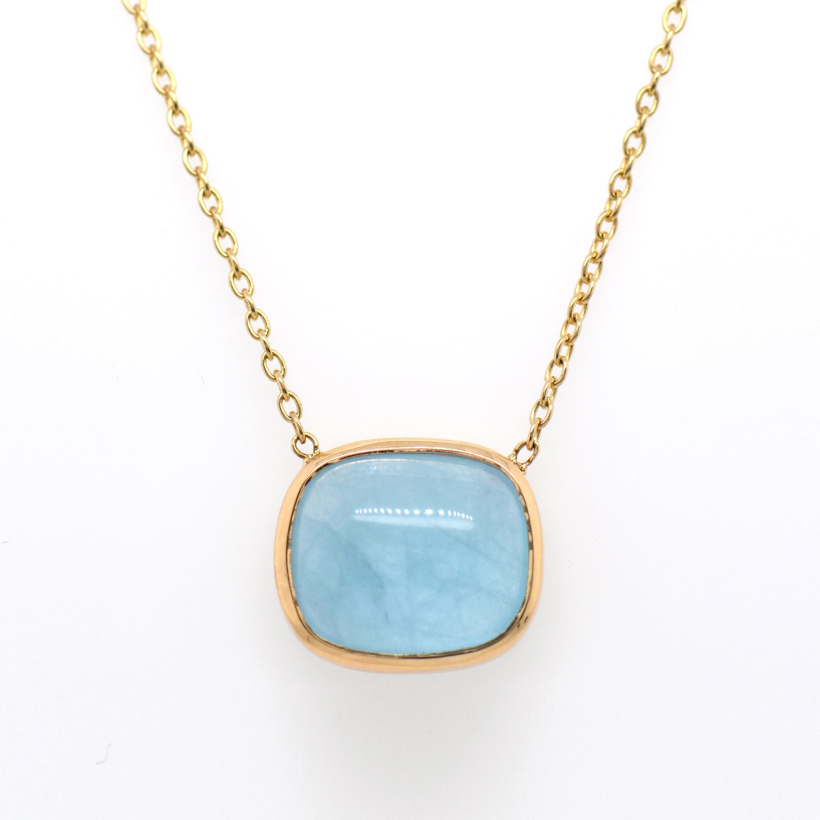14K yellow gold aquamarine necklace featuring 1 cabochon-cut blue aquamarine weighing 12.33 carats in a bezel setting.
