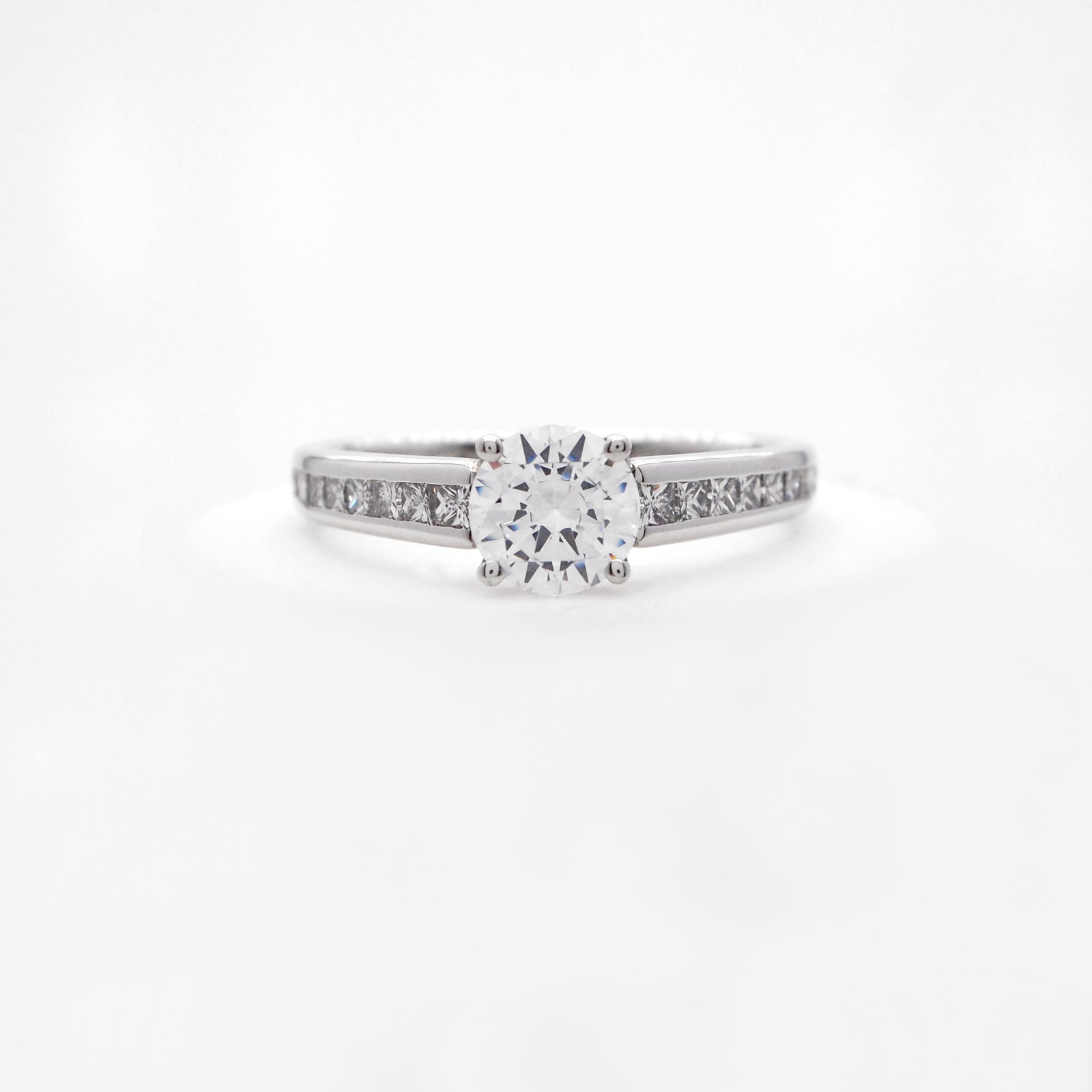 Platinum diamond engagement ring featuring princess cut diamonds weighing a total of 0.47 carats. 