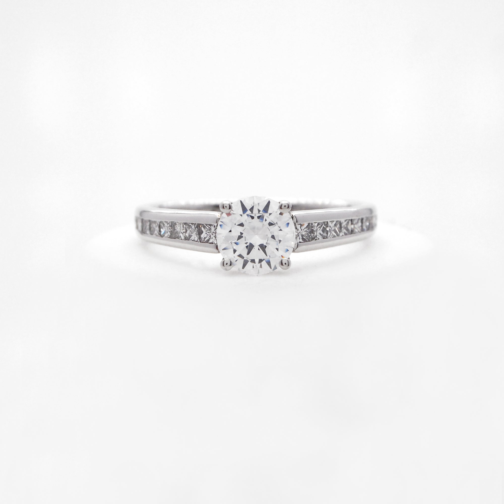 Platinum diamond engagement ring featuring princess cut diamonds weighing a total of 0.47 carats. 