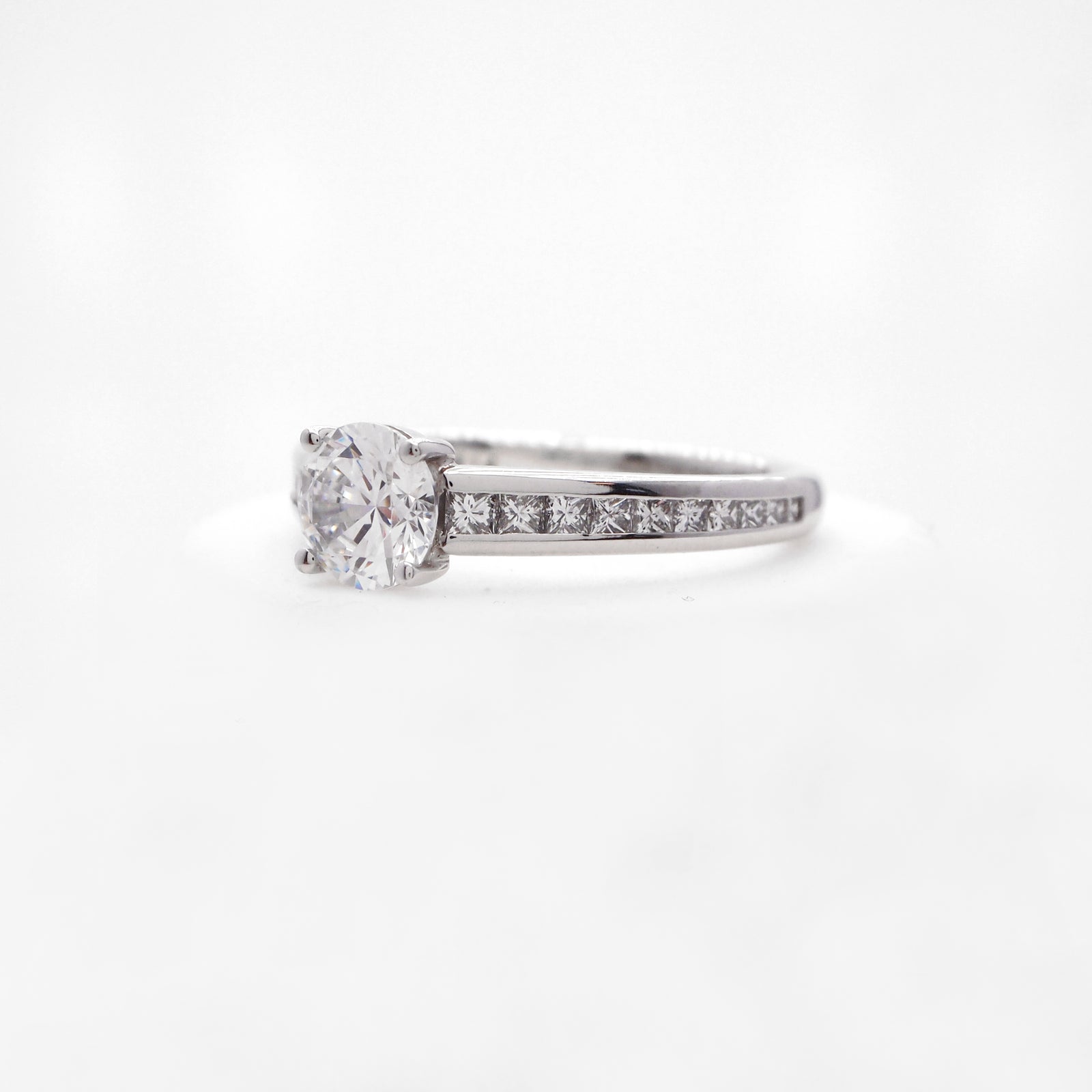 Platinum diamond engagement ring featuring princess cut diamonds weighing a total of 0.47 carats. 