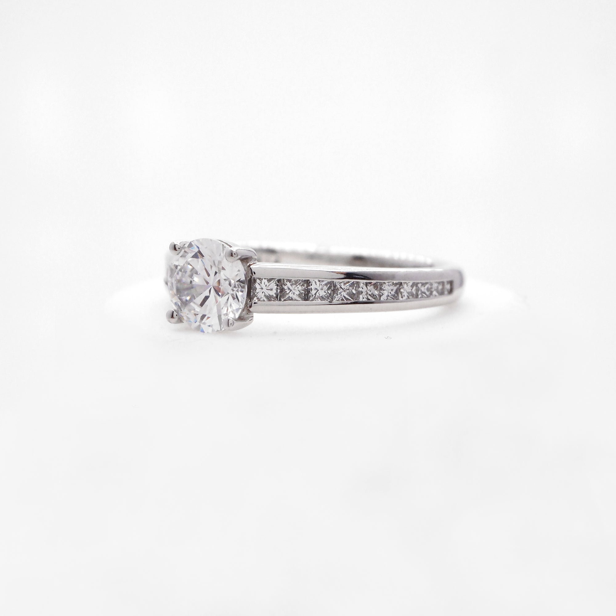 Platinum diamond engagement ring featuring princess cut diamonds weighing a total of 0.47 carats. 