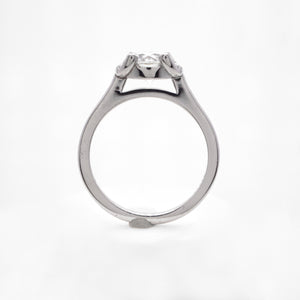 Platinum engagement ring featuring a crescent halo with round brilliant diamonds weighing a total of 0.04 carats. This