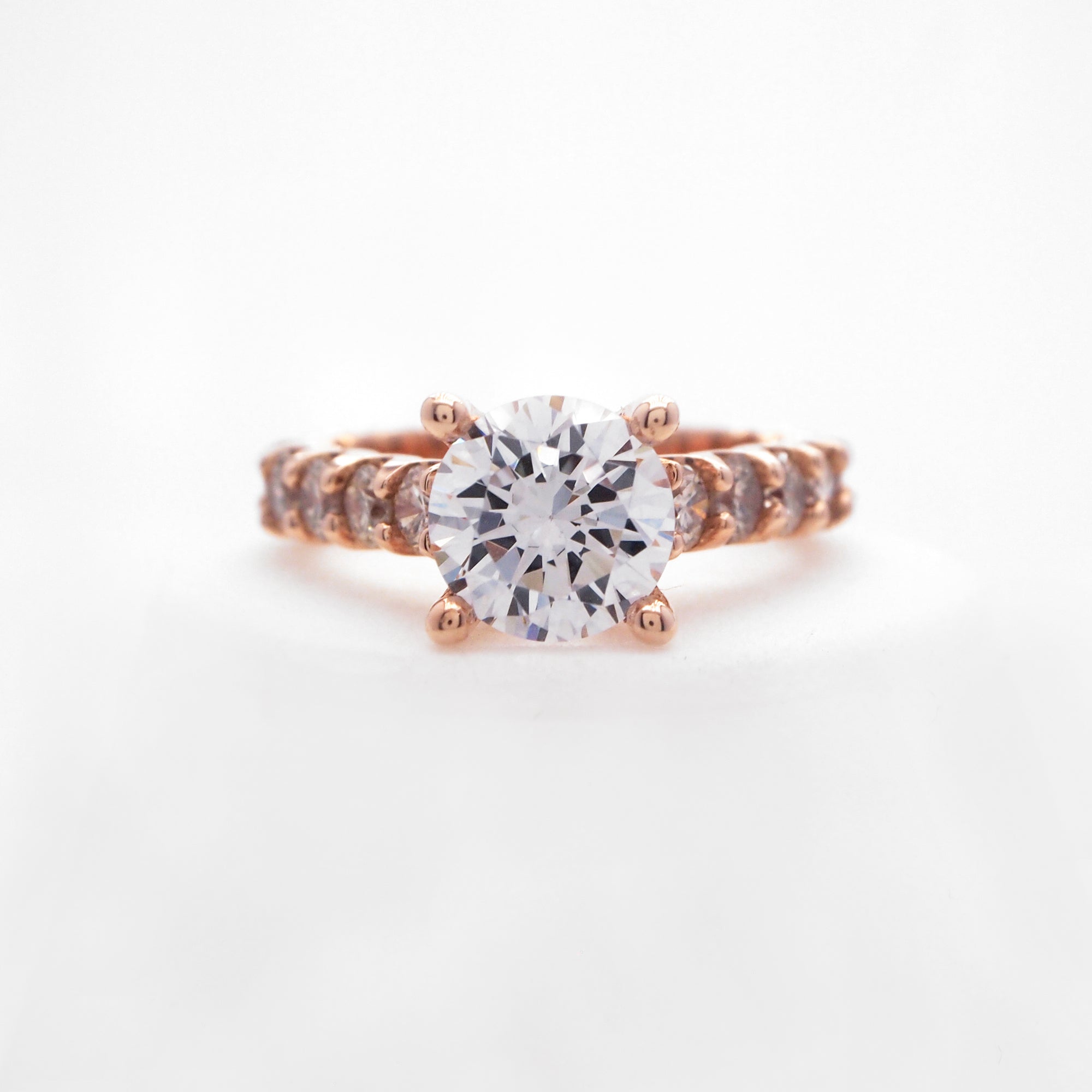 14K rose gold diamond engagement ring with round brilliant diamonds weighing a total of 1.40 carats. 