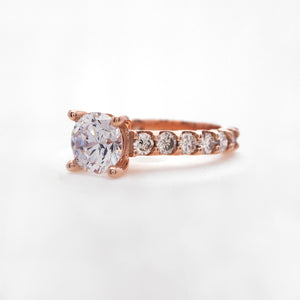 14K rose gold diamond engagement ring with round brilliant diamonds weighing a total of 1.40 carats. 