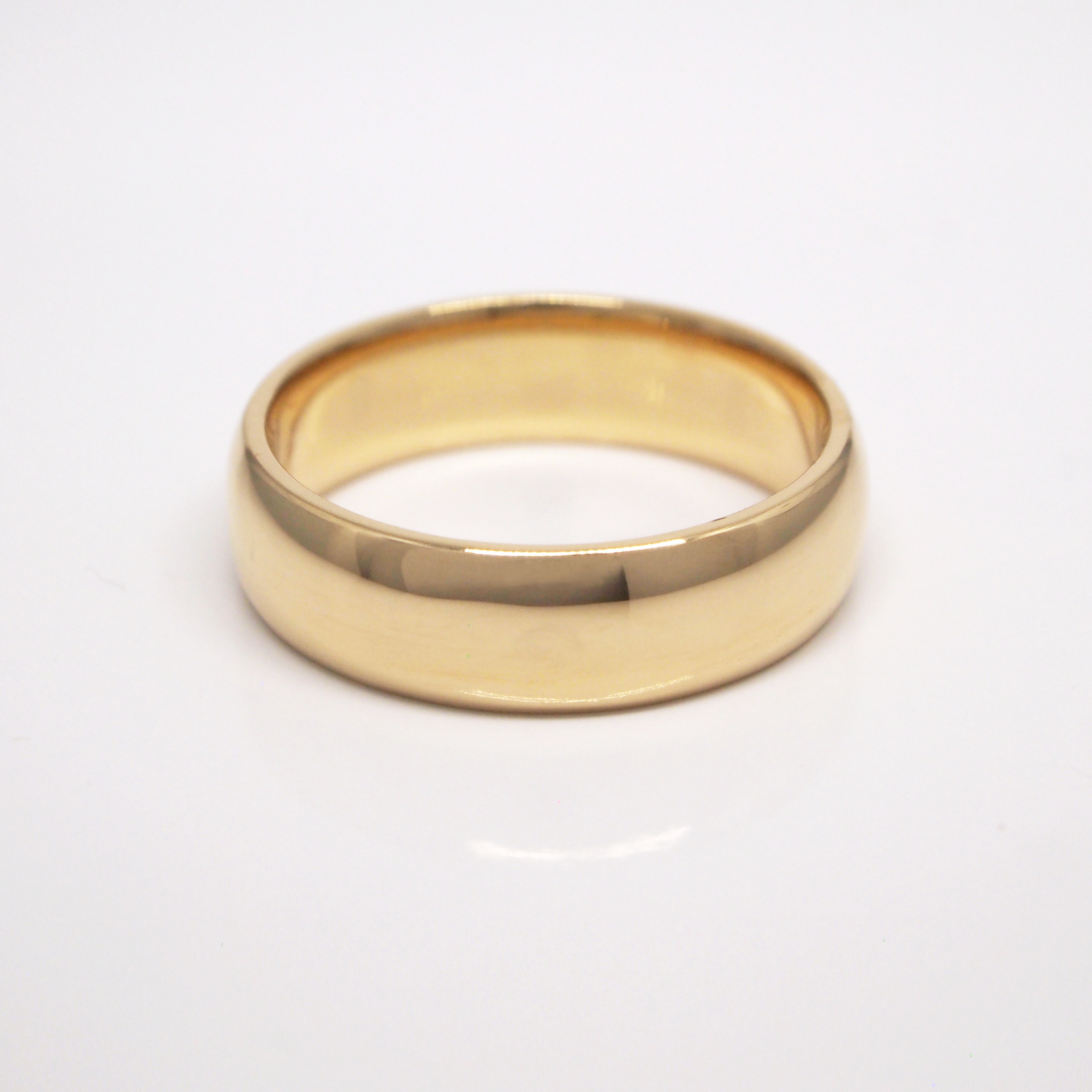 14K yellow gold regular weight 6mm domed wedding band featuring high polish finish.