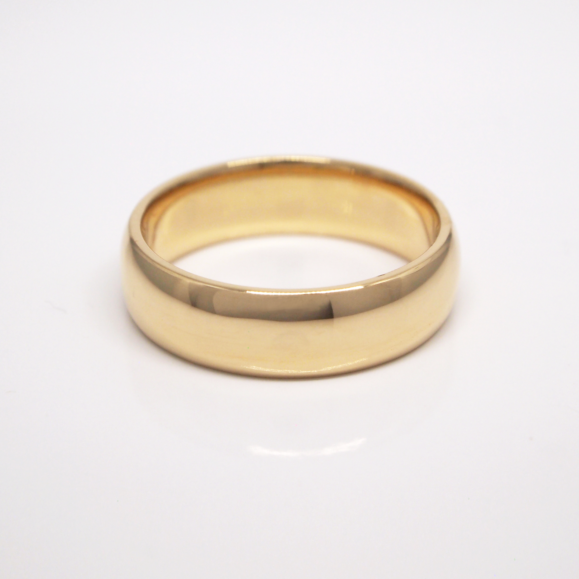 14K yellow gold regular weight 6mm domed wedding band featuring high polish finish.