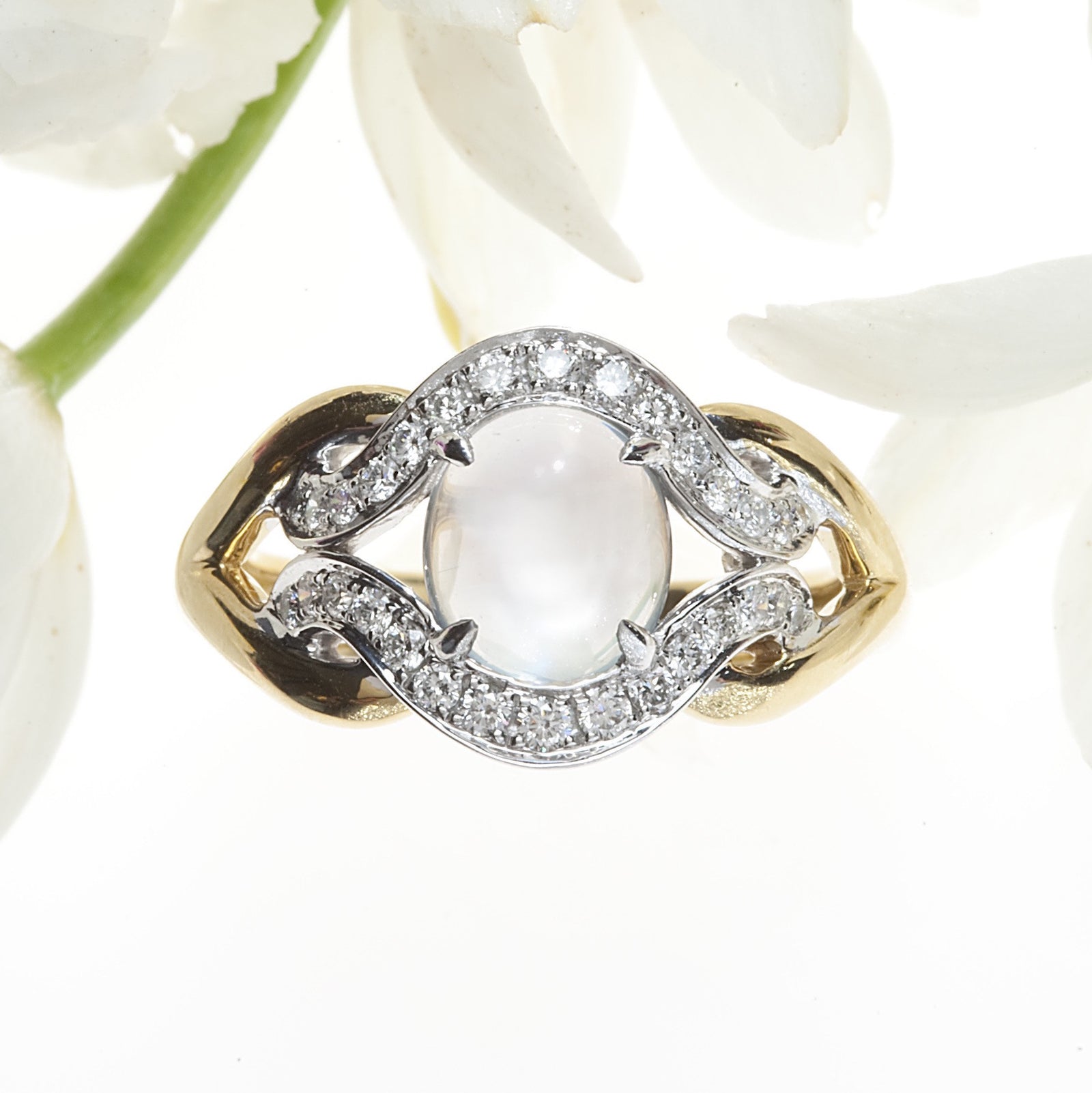 Angled View of White and Yellow Gold Two Tone Cabochon Cut Moonstone Ring with Round Brilliant Diamonds