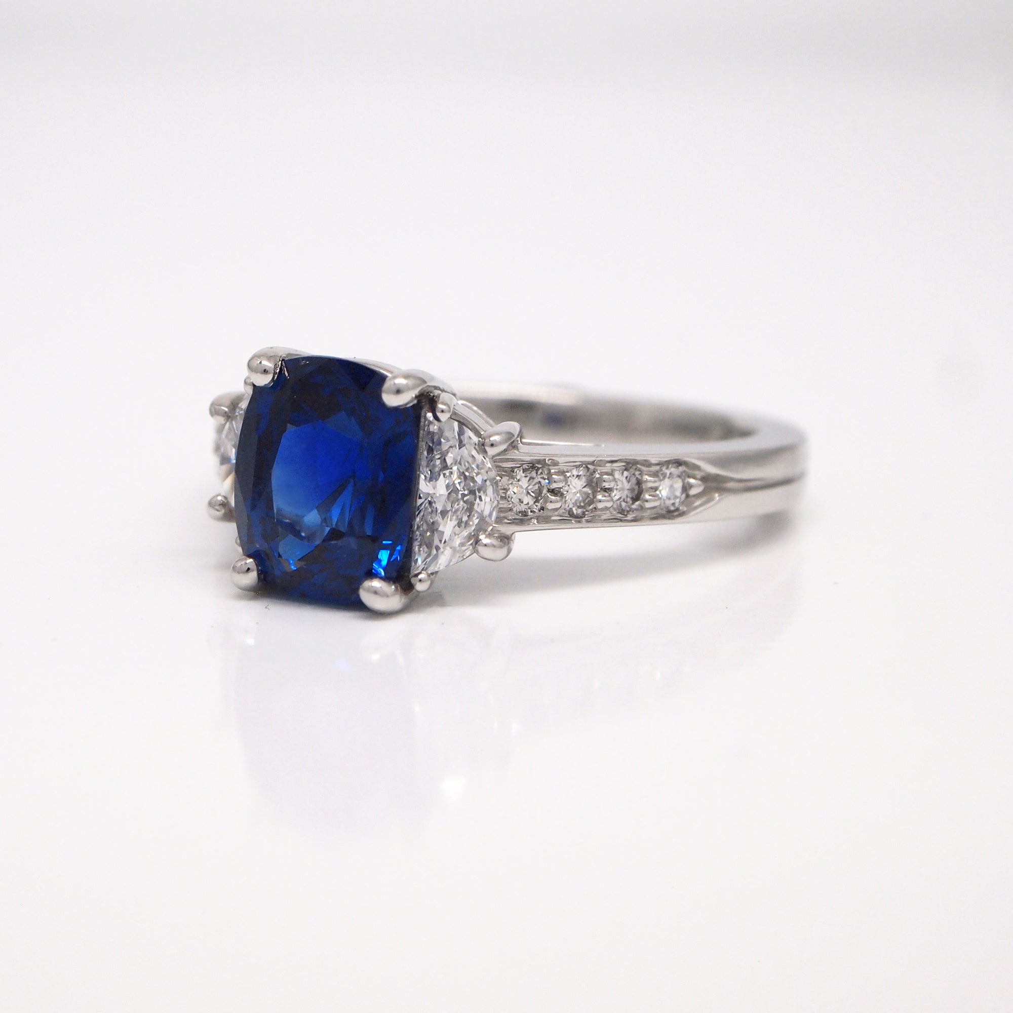 Platinum cushion cut sapphire and diamond engagement ring