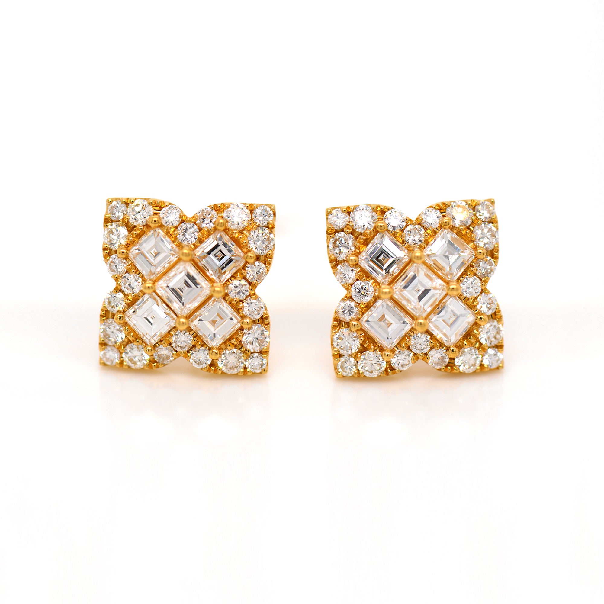 18K yellow gold diamond earrings featuring Asscher and round diamonds weighing a total of 2.78 carats set in a 4-point clover design.