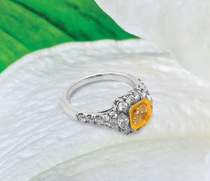 18K white gold diamond engagement ring featuring a 0.74 carat natural fancy yellow diamond bezel set in yellow gold, and marquis round diamonds weighing a total of 0.99 carats. Total diamond weight: 1.73ctw.