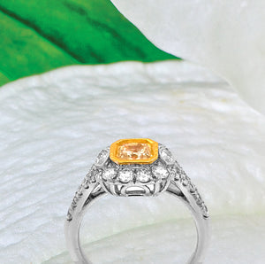 18K white gold diamond engagement ring featuring a 0.74 carat natural fancy yellow diamond bezel set in yellow gold, and marquis round diamonds weighing a total of 0.99 carats. Total diamond weight: 1.73ctw.