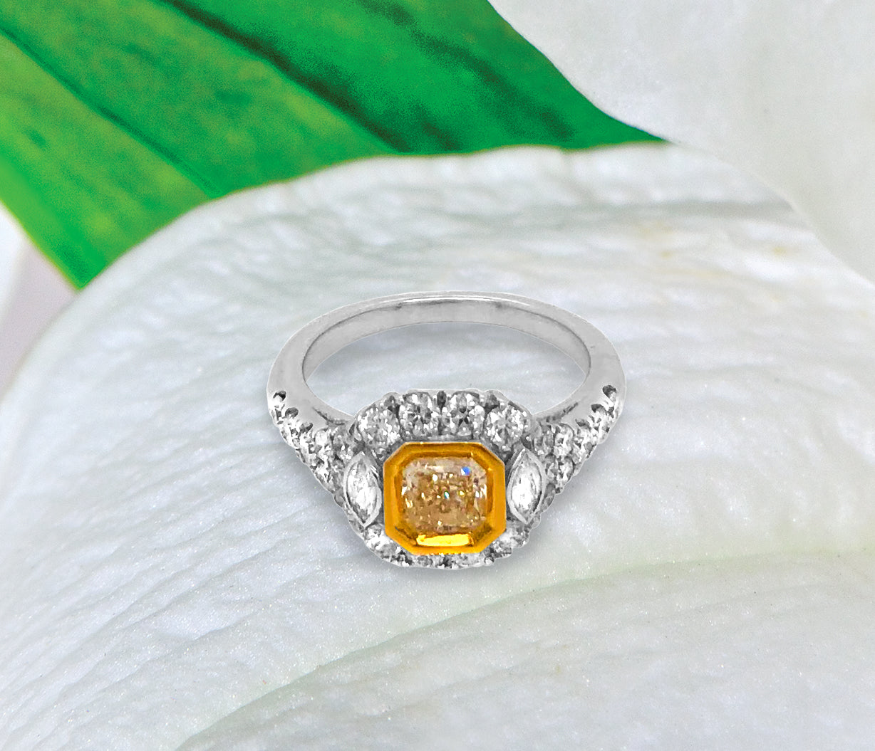 18K white gold diamond engagement ring featuring a 0.74 carat natural fancy yellow diamond bezel set in yellow gold, and marquis round diamonds weighing a total of 0.99 carats. Total diamond weight: 1.73ctw.