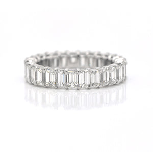 Platinum diamond eternity band featuring 27 emerald-cut diamonds (H color, VS clarity) weighing a total of 4.26 carats.