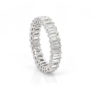 Platinum diamond eternity band featuring 27 emerald-cut diamonds (H color, VS clarity) weighing a total of 4.26 carats.