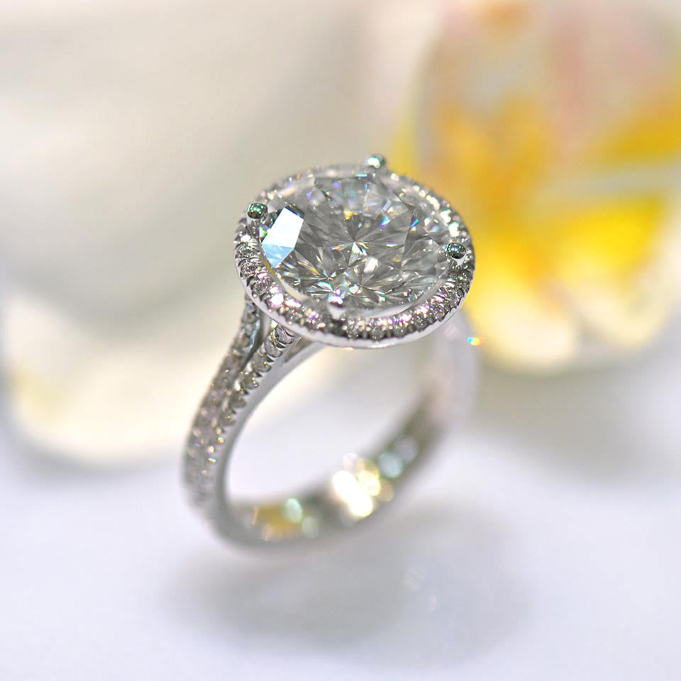 14K diamond engagement ring featuring 1 round brilliant diamond set in a diamond halo, and round brilliant diamonds in a split-shank design. Custom-made to order for any size diamond or gemstone center stone. Available in 14K or 18K white, yellow, rose gold, and platinum. 