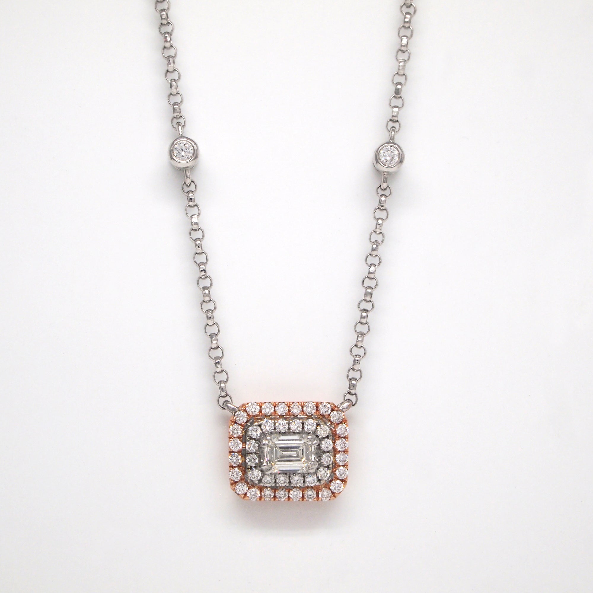 14K rose gold and white gold necklace with 1 emerald-cut diamond weighing 0.31 carats, and 42 brilliant cut diamonds weighing a total of 0.30 carats.