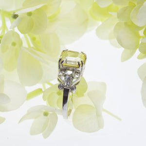 Side view of one natural unheated, untreated asscher-cut yellow sapphire weighing 3.92 carats set in a platinum antique setting, ring