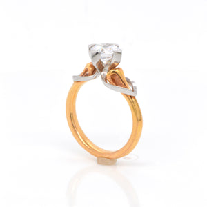 Maevona Round brilliant-cut solitaire named after the Scottish island of Eriskay with a platinum and rose gold setting and heart-shaped shoulders, flowing around a swan-neck shank. Judith Arnell Jewelers
