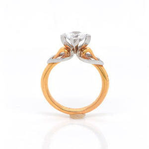 MaeVona Round brilliant-cut solitaire named after the Scottish island of Eriskay with a platinum and rose gold setting and heart-shaped shoulders, flowing around a swan-neck shank. Judith Arnell Jewelers