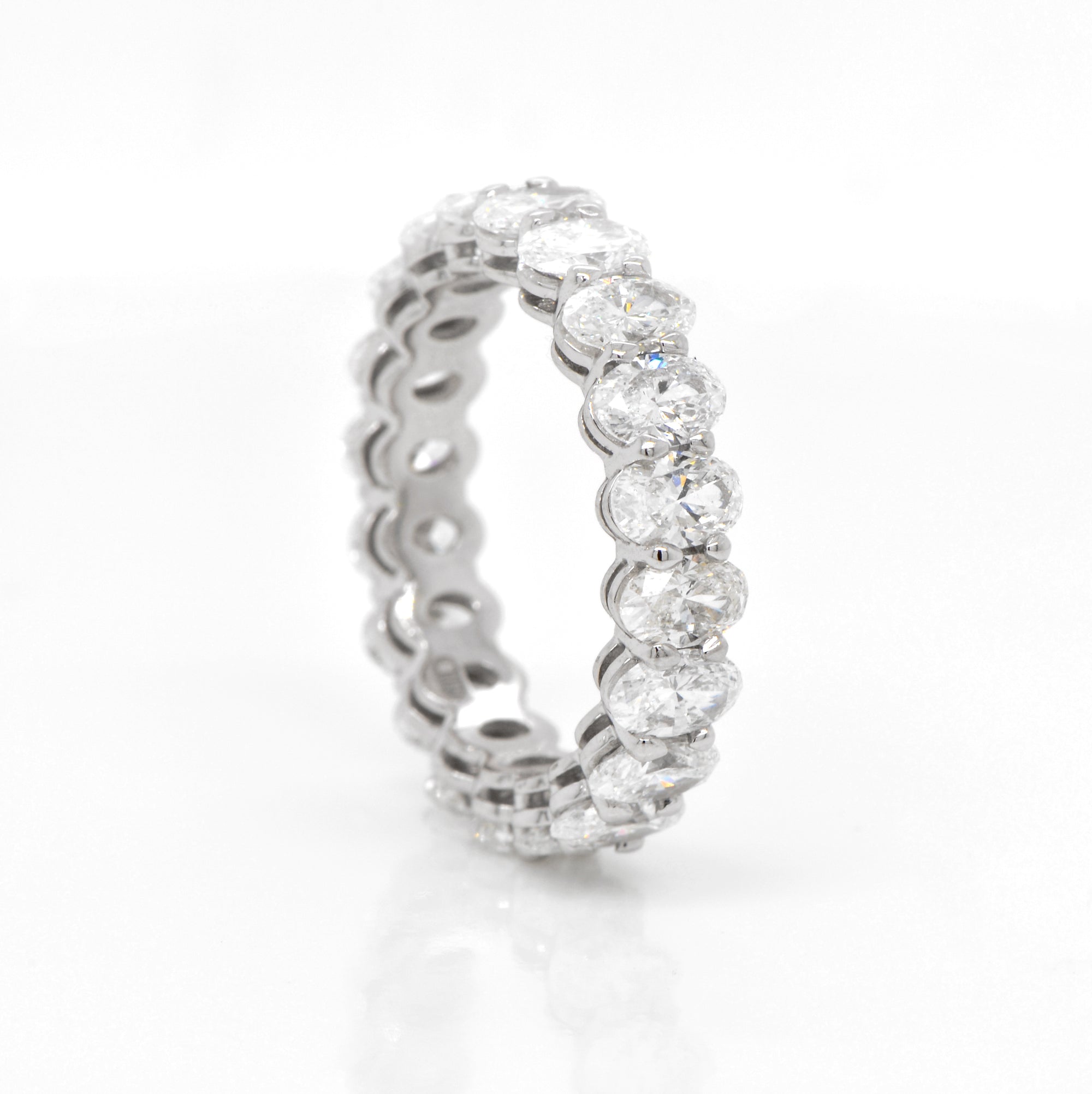 Platinum oval diamond eternity band featuring 20 oval diamonds (F-G color, VS-SI clarity) weighing a total of 4.09 carats.