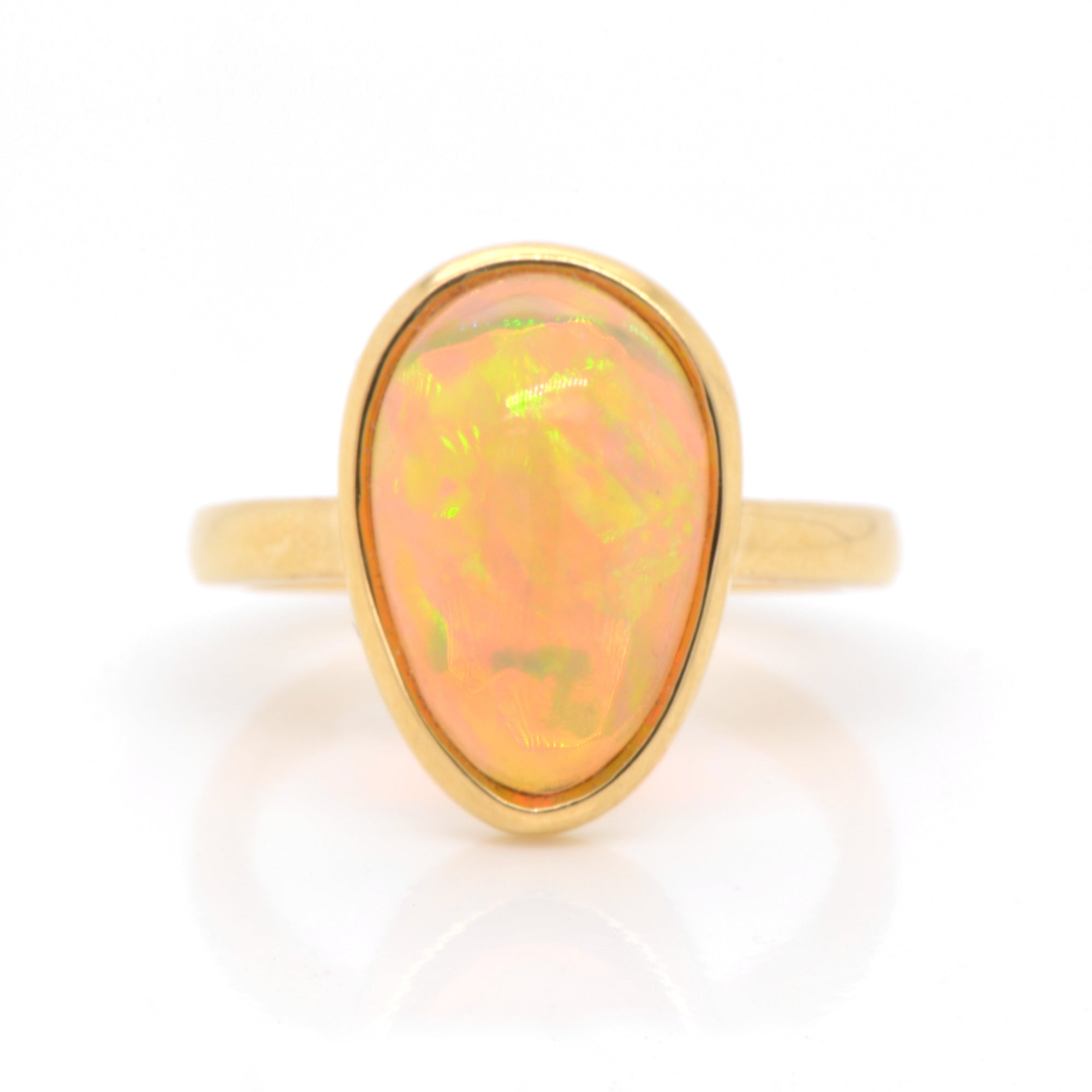 18K yellow gold opal ring featuring one pear-shaped Ethiopian opal weighing 3.52 carats. Judith Arnell Jewelers.