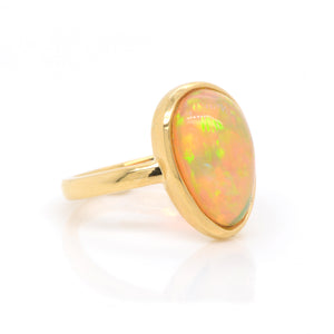 18K yellow gold opal ring featuring one pear-shaped Ethiopian opal weighing 3.52 carats. Judith Arnell Jewelers.