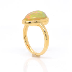 18K yellow gold opal ring featuring one pear-shaped Ethiopian opal weighing 3.52 carats. Judith Arnell Jewelers.