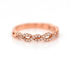 14K rose gold diamond band featuring round brilliant diamonds weighing a total of 0.26 carats set in an interwoven twist design. 
