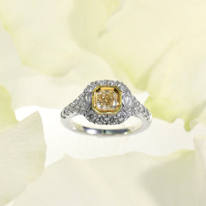 18K white gold diamond engagement ring featuring a 0.74 carat natural fancy yellow diamond bezel set in yellow gold, and marquis round diamonds weighing a total of 0.99 carats. Total diamond weight: 1.73ctw.