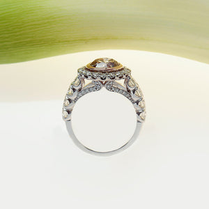 profile view of a handmade platinum and rose gold ring with a brown pink diamond and white diamonds