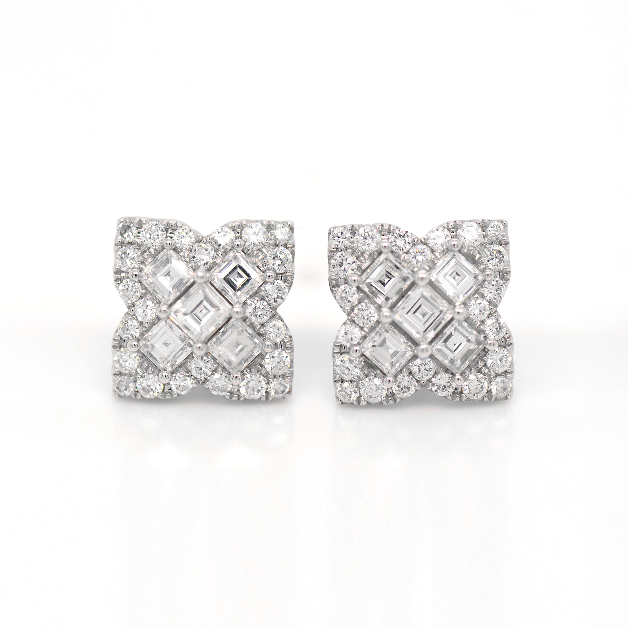 18K white gold diamond earrings feature Asscher and round diamonds weighing a total of 2.69 carats set in a 4-point clover design.