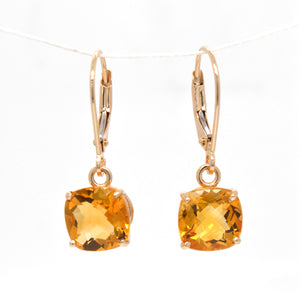 14K yellow gold citrine earrings featuring 2 golden yellow-orange cushion-shaped citrines measuring 8x8 mm.