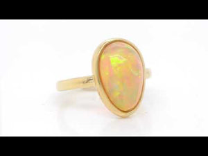 18K yellow gold opal ring featuring one pear-shaped Ethiopian opal weighing 3.52 carats. Judith Arnell Jewelers.