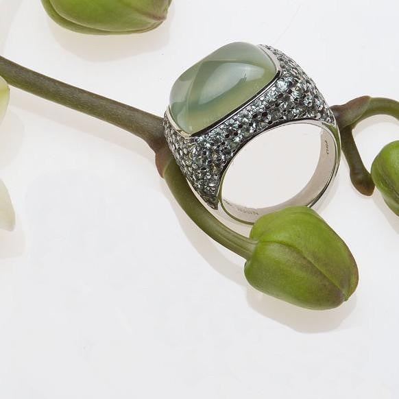 Angled view of white gold prehnite and pave set mint green sapphire ring